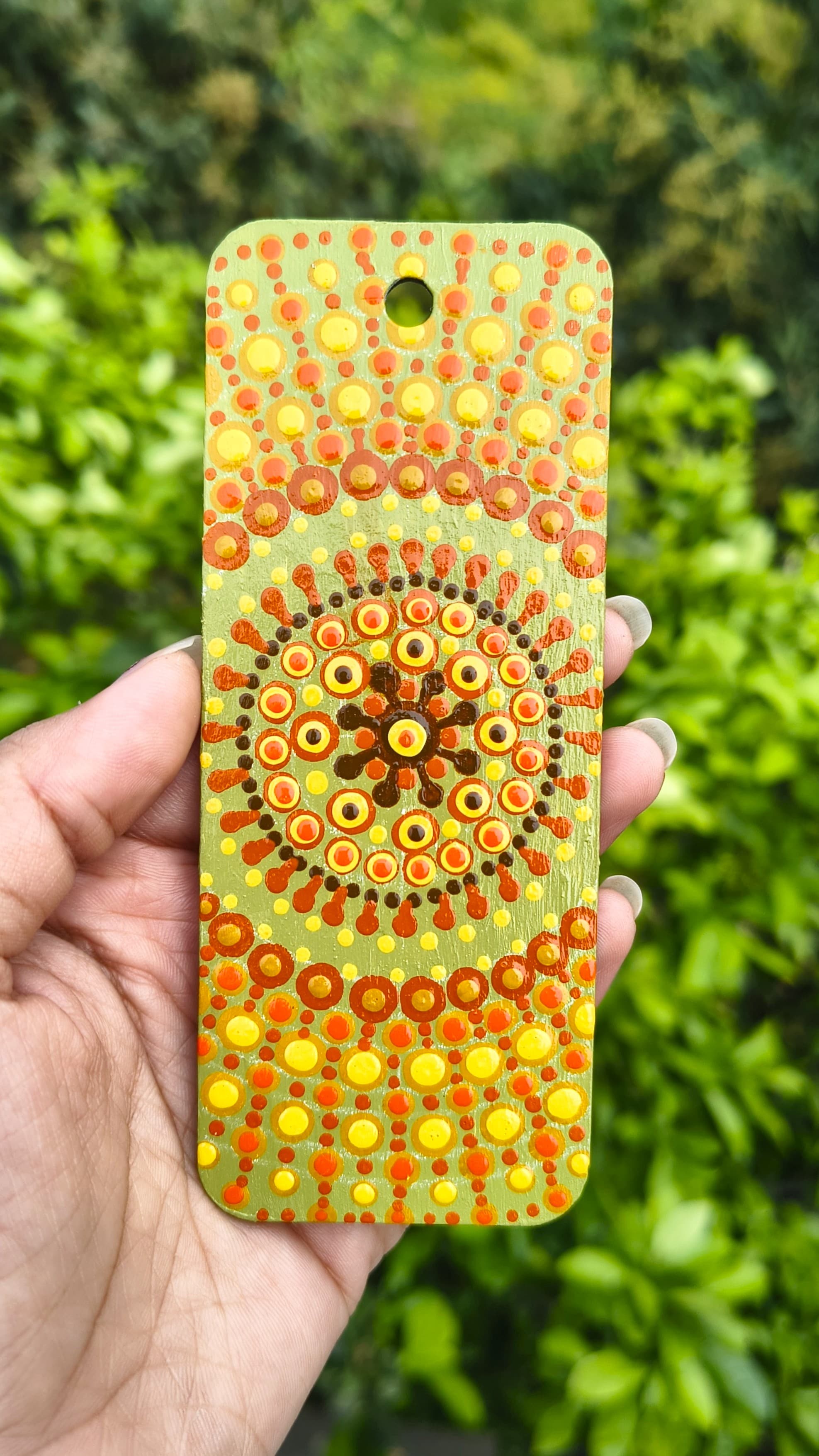 Olive green mandala bookmark with orange and red dot patterns