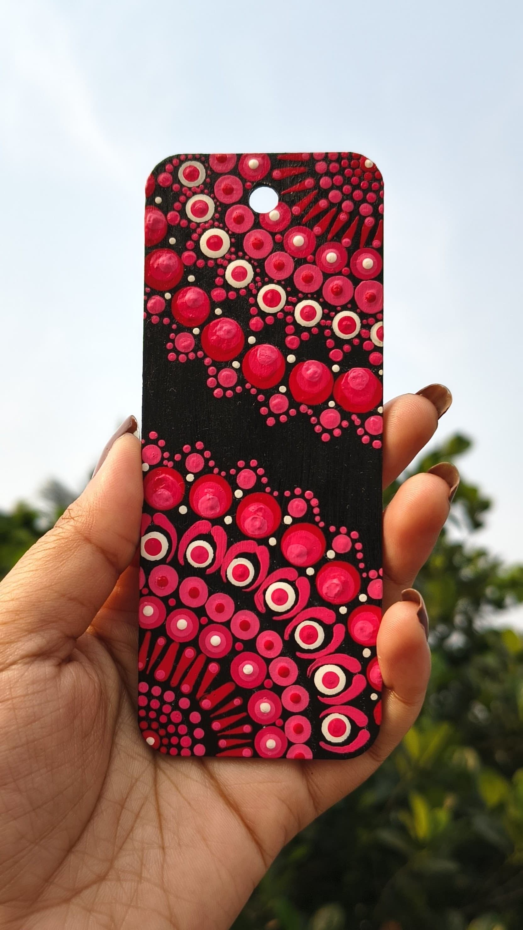 Red mandala with white concentric dot patterns in radial symmetry