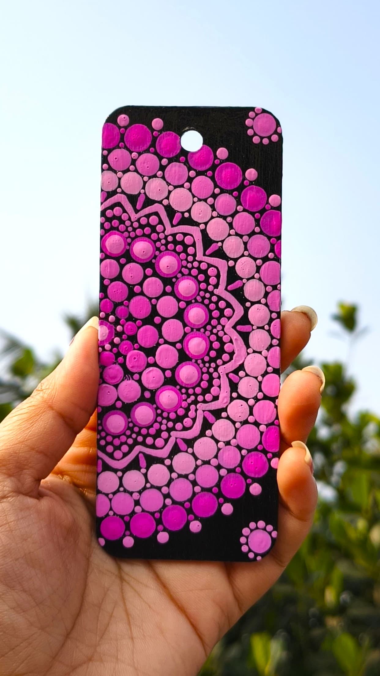 Pink and magenta mandala bookmark on black background